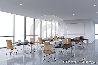 Corporate workplaces equipped by modern laptops in a modern panoramic office, white copy space in the windows. Brown leather chair Stock Photo