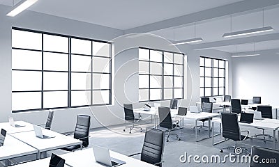 Corporate workplaces equipped by modern laptops in a modern panoramic office with white windows. Black leather chairs and white ta Stock Photo