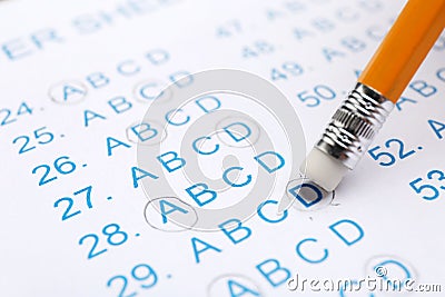 Correcting mistake with pencil eraser in answer sheet Stock Photo