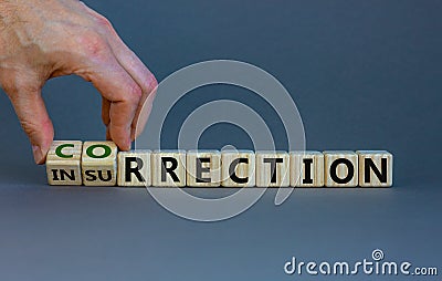 Correction vs insurrection symbol. Businessman turns wooden cubes and changes word `insurrection` to `correction`. Beautiful g Stock Photo