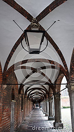 Corridor of arches, old brick tunnel with lanterns, Market Square, Lubeck, Germany Stock Photo