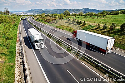 Corridor highway with the transition for animals, going down the highway two trucks Stock Photo