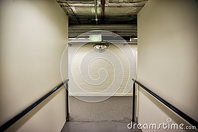 Corridor inside a building with blind corners and a convex safety mirror Stock Photo