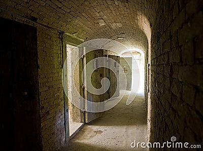 Corridor to isolation cells in an abandoned prison Stock Photo