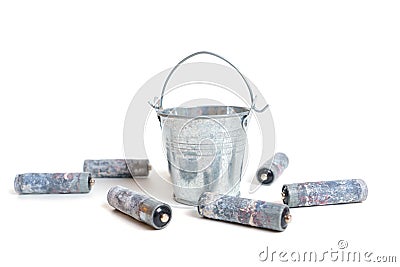 Corroded batteries by a small bucket on white Stock Photo