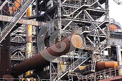 Landschaftspark Duisburg, Germany: Corroded rusty tube protrude from steel tower with staircases Editorial Stock Photo