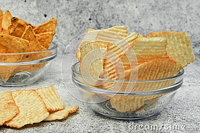 Corrugated potato chips corn chips in a glazed transparent saucepan. Snack, junk food. Close up. Stock Photo