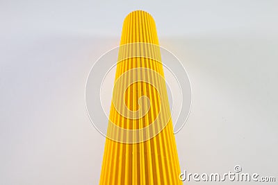 Corrugated yellow paper rolls on the white desk. Stock Photo
