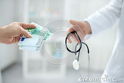 Corrupt doctor accept money from patient Stock Photo