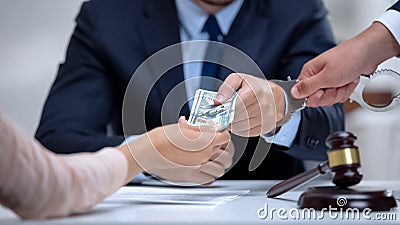 Corrupt judge handcuffed when taking dollar bribe in court, anti-corruption law Stock Photo