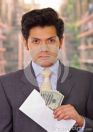 Corrupt politician put some money inside of an envelope Stock Photo