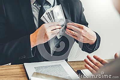 Corruption concept,Business man passing money dollar bills corruption bribery to businessman manager Stock Photo
