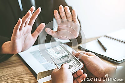 Corruption concept,Businessman manager refusing receive money from Business man passing money dollar bills corruption bribery Stock Photo