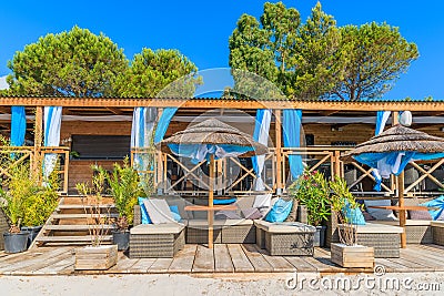 Beach bar on sea coastLuxury beach bar with sofas on sandy Palombaggia beach, Corsica island, France Stock Photo