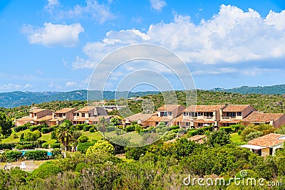 Holiday houses on green hillsTypical Corsican villa houses on green hill in rural landscape of Corsica island, France Stock Photo