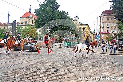 Cortege with riders on horseback on the streets in historical city center, Lviv Editorial Stock Photo