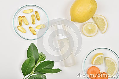 Cosmetic bottle containers with fresh lemon slices, Blank label for branding mock-up, Natural Vitamin C skincare Stock Photo