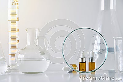 Cosmetic brown bottle containers and scientific glassware, Focus on blank label package for branding mock-up. Stock Photo