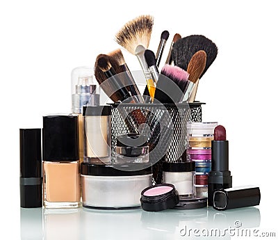 Cosmetic brush, eye shadow, liquid base, lipstick, jar cream isolated. Stock Photo