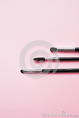 Cosmetic brushes for makeup on a pink background, fashion and beauty Stock Photo