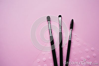 Cosmetic brushes for makeup on a pink background, fashion and beauty Stock Photo