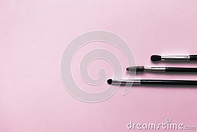 Cosmetic brushes for makeup on a pink background, fashion and beauty Stock Photo