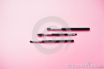 Cosmetic brushes for makeup on a pink background, fashion and beauty Stock Photo