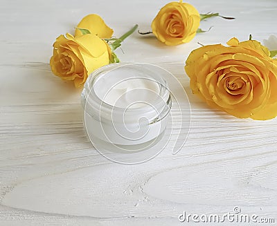 Cosmetic cream, glass yellow rose ointment face care revitalize on a table white wooden background Stock Photo
