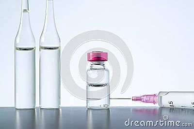 Cosmetic injections bottle - botox, filler, collagen and hyaluronic acid solution. medical glass vial plastic single use syringe Stock Photo