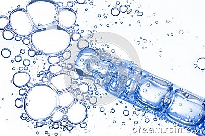 Cosmetic liquid dropper macro with clear blue serum in pipette with bubbles isolated on white Stock Photo
