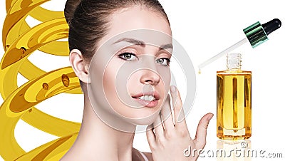 Cosmetic oil applying on face of young woman. Stock Photo