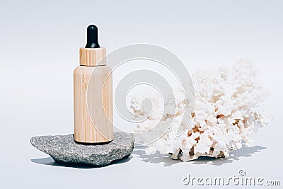 Cosmetic oil with natural Dead Sea minerals in wooden dropper bottle against white background Stock Photo