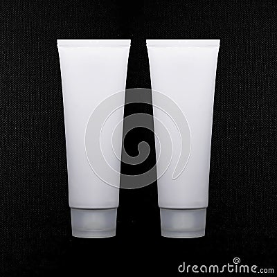 Cosmetic packaging design. White cream tube. Cosmetics mockup for branding. Beauty makeup product. texture black background Stock Photo