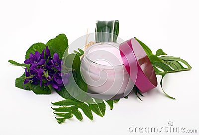 Cosmetic pink cream with herbs and flowers Stock Photo