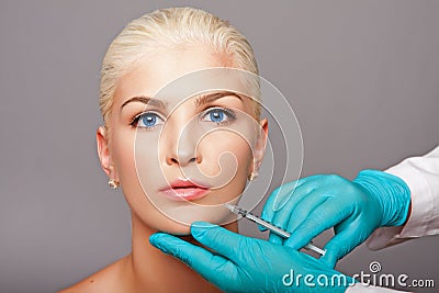 Cosmetic plastic surgeon injecting aesthetics face Stock Photo