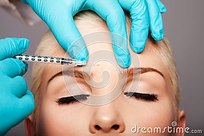 Cosmetic plastic surgeon injecting aesthetics face Stock Photo