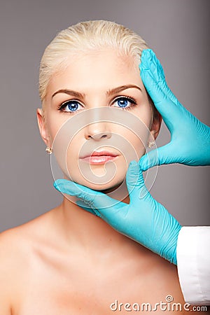 Cosmetic plastic surgeon touching aesthetics face Stock Photo