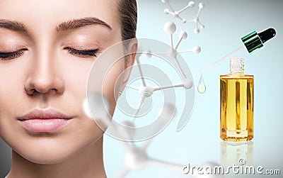 Cosmetic primer oil near woman face with big molecule chain. Stock Photo