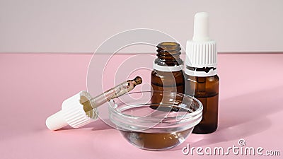 cosmetic product, bottle with hyaluronic acid on a pink background, close-up Stock Photo