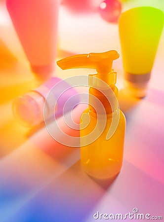 Cosmetic product creative still life. Colorful Cosmetic package collection on abstract spectrum neon background. Beauty care Stock Photo