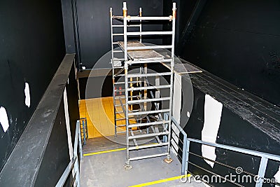 Cosmetic repair of the stairwell walls using modern metallic tubular multilevel scaffolding Stock Photo