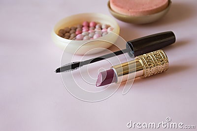 Cosmetic rouge, lipstick and mascara on pink background Stock Photo