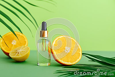 Cosmetic serum Vitamin C in glass bottle with pipette dropper. Orange essential oil with citrus ingredients Vitamin C Stock Photo