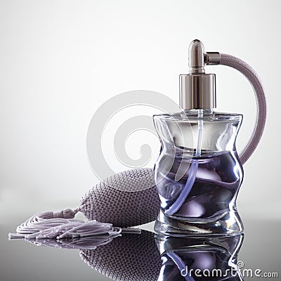 Cosmetic spray perfume on a gray background with reflection Stock Photo