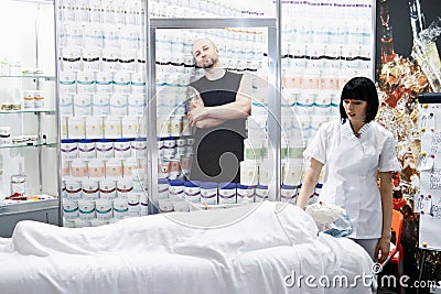 Cosmetician doing cosmetic mask Editorial Stock Photo