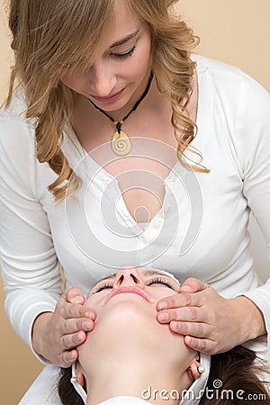 Cosmetician giving customer face massage Stock Photo