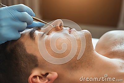 Cosmetician using blackhead remover Stock Photo