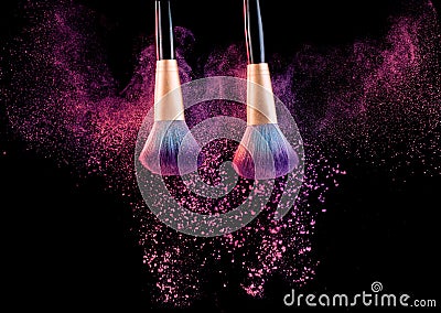 Cosmetics brush with powder explosion on black Stock Photo