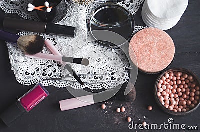 Cosmetics on a dark background, close-up. Face care, make-up. Items for applying makeup. The world of a woman Stock Photo