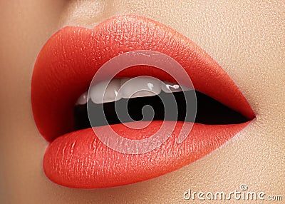 Cosmetics, makeup. Bright lipstick on lips. Closeup of beautiful female mouth with red and pink lip makeup. Part of face Stock Photo